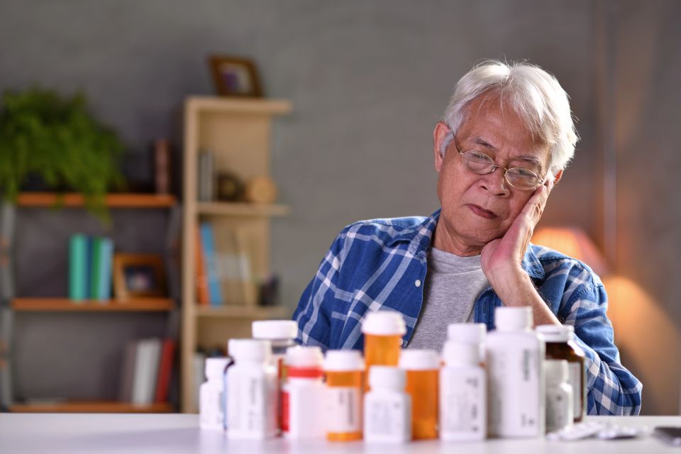 Asian senior man with his medicine bottles