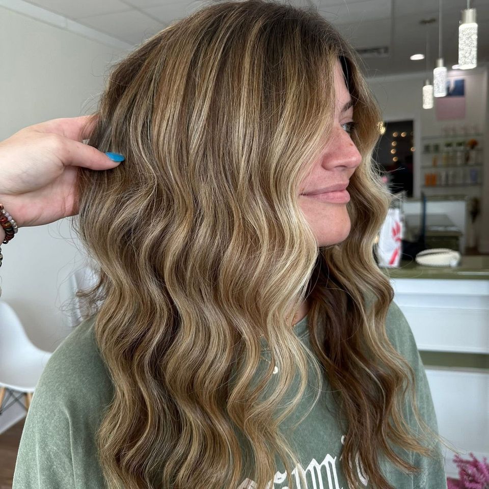 Long wavy bronde balayage with face framing blonde highlights after color service in Columbiana AL