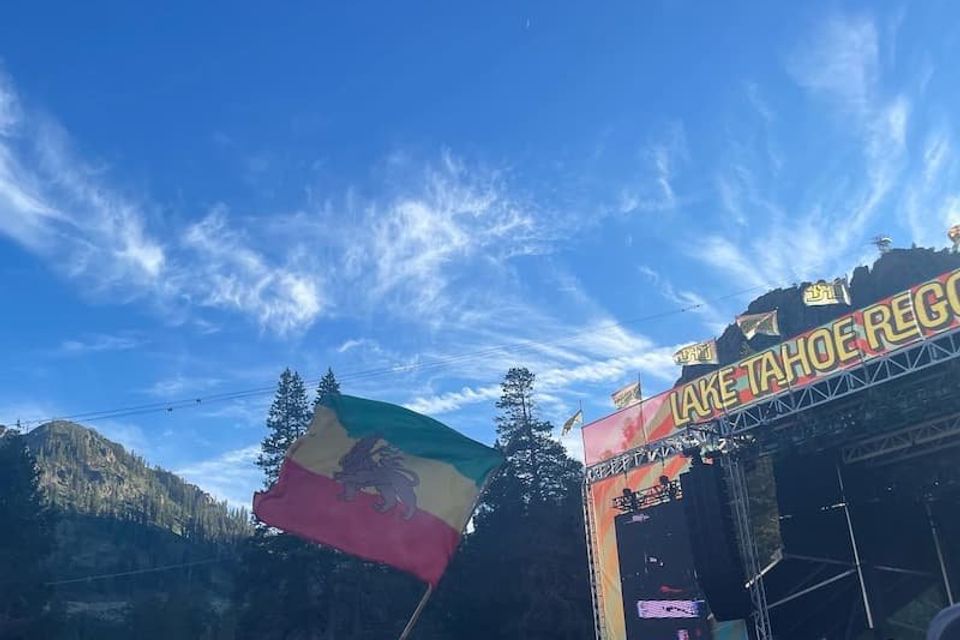 Lake Tahoe Reggae Festival with Jamaica flag flying with a blue sky background at the Palisades, CA 