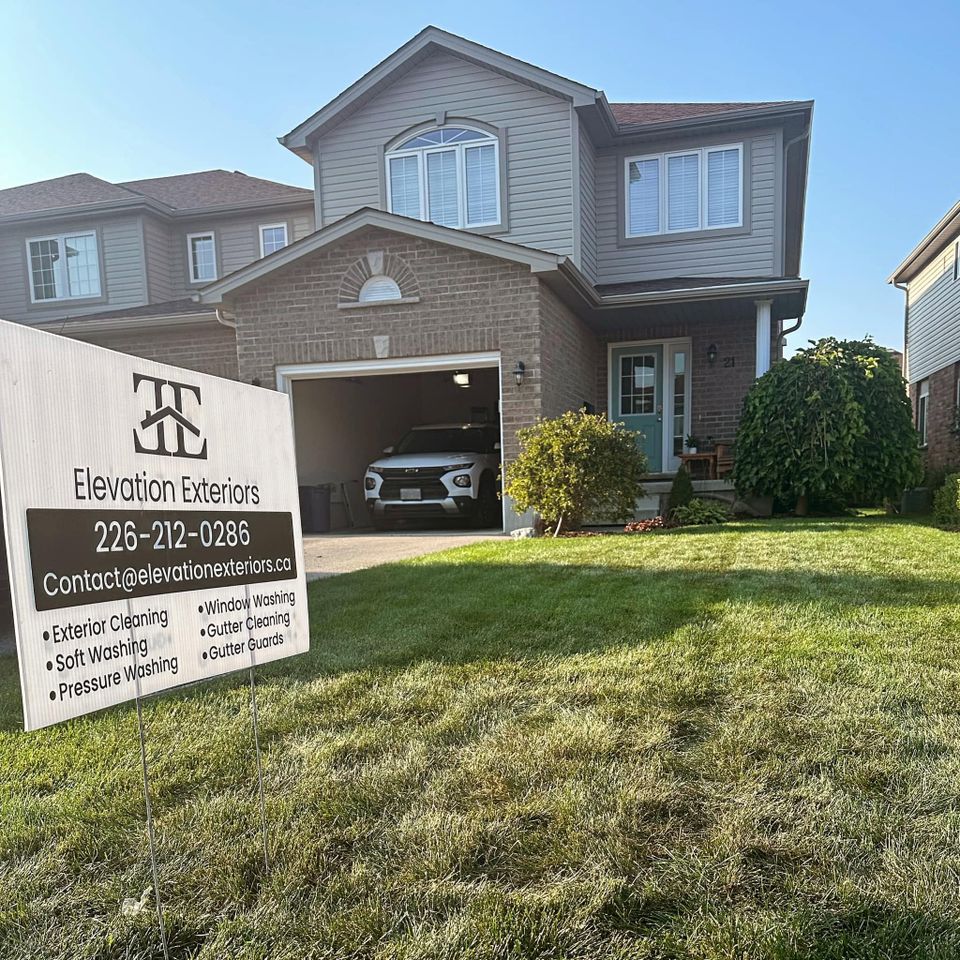 Elevation Exteriors lawn sign in front of a two-story home after exterior cleaning in Tillsonburg Ontario