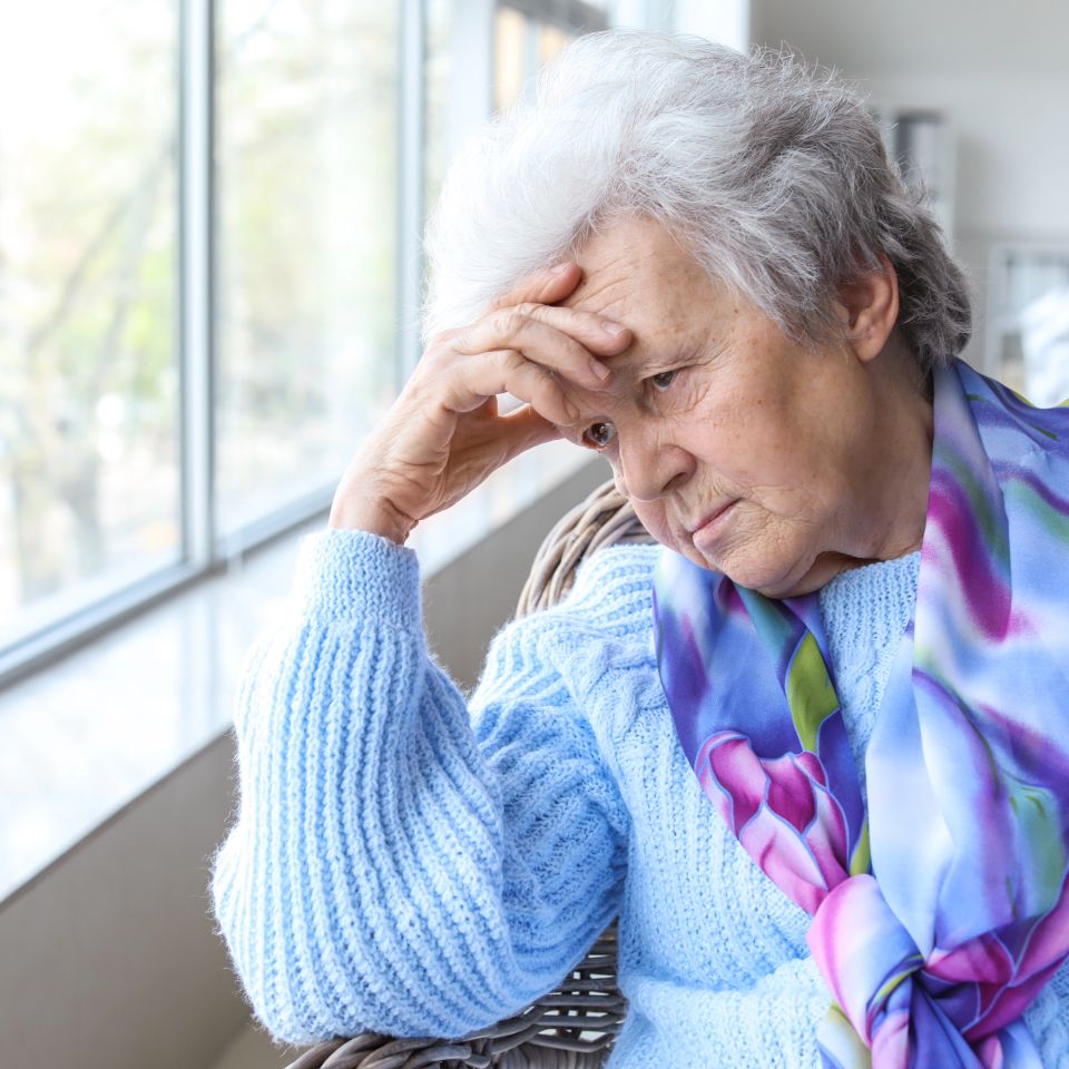 Portrait of sad senior woman in nursing home