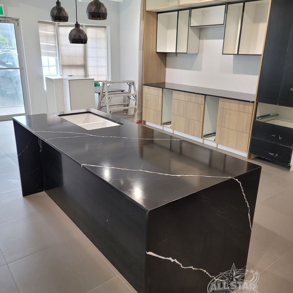 Black stone kitchen island with custom countertop installation in Houston, TX