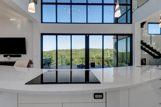 Symphony house kitchen stove and outside firepit view