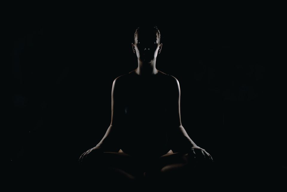 Silhouette of a person in a meditation position