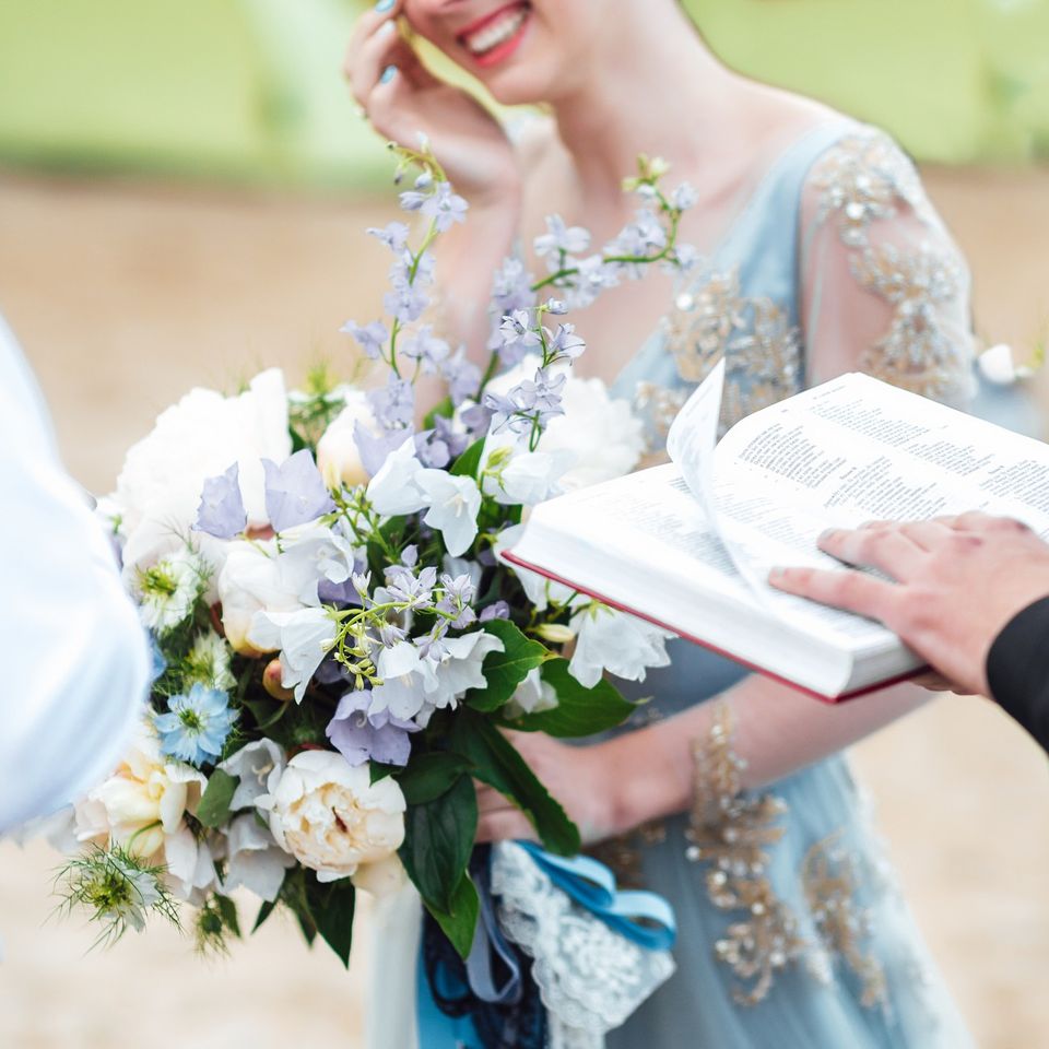Bride smiling while holding flowers during wedding moment