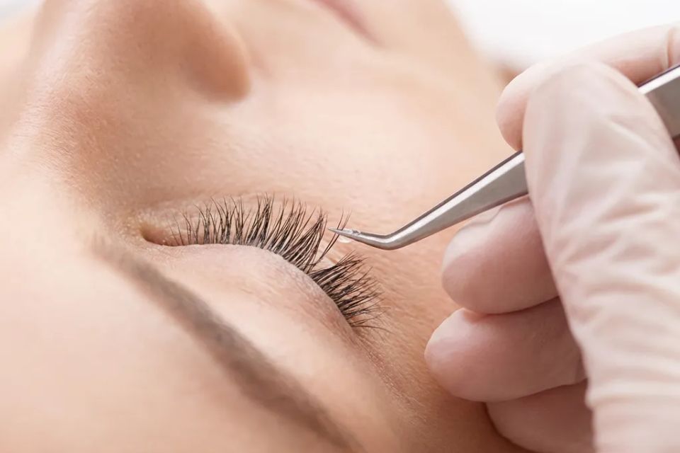  Individual eyelash extension application close up for natural volume look