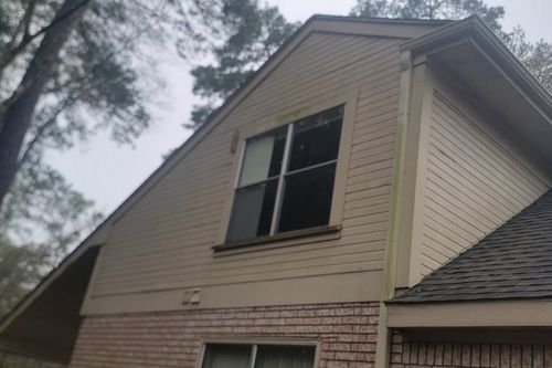 Fresh caulk and paint at gable‑end Hardie siding in Katy, TX