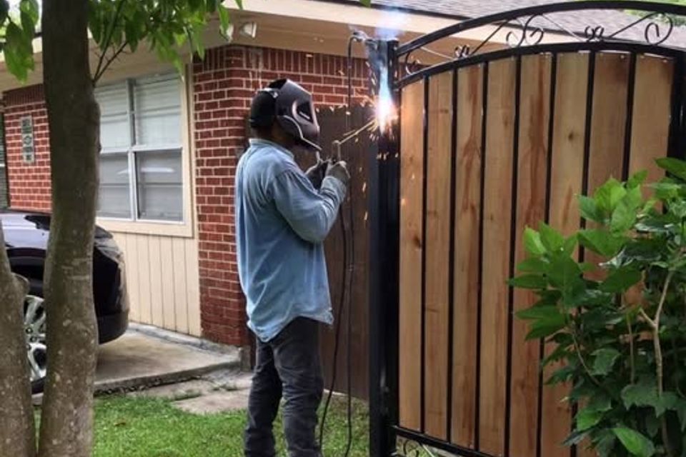 Marquez welding image welder working with a wrough iron gate