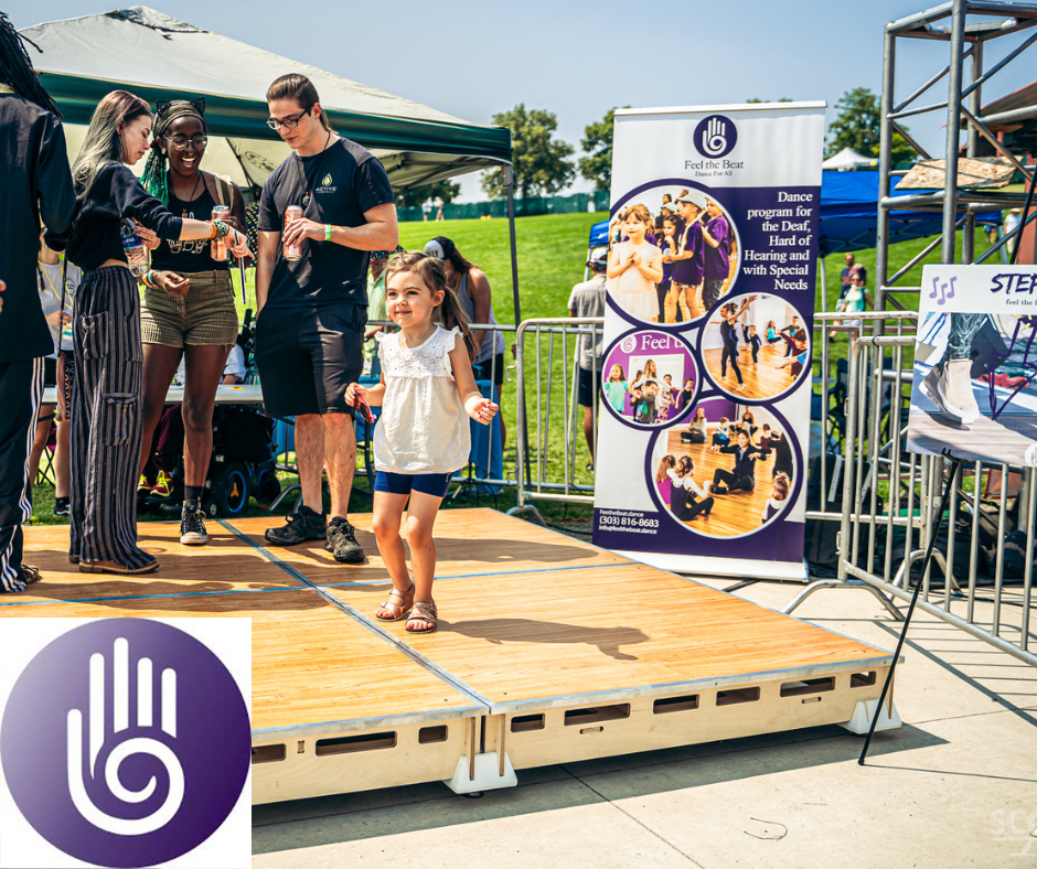 The Feel The Beat dance floor at Shine Music Festival 2021. There is a little girl dancing on the floor with others standing behind her and the FTB banner is in the background.