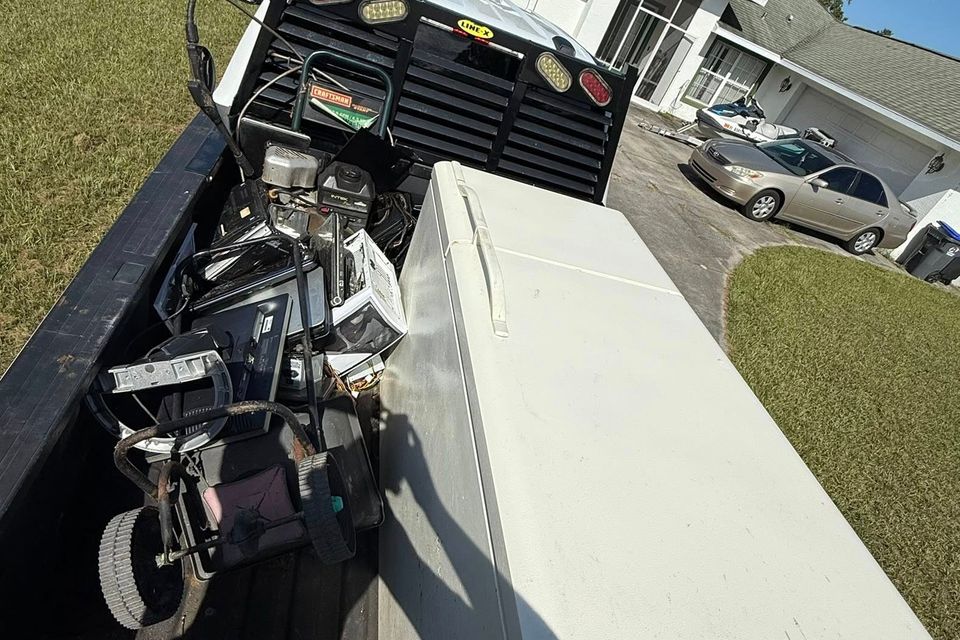 A refrigerator in the back of the JNJ Hauling Solutions truck prepared for transportation