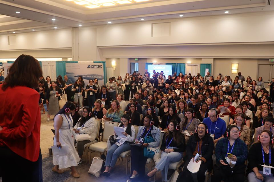 Woman speaking to room full of people