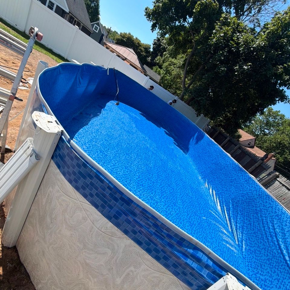 Above ground pool with fresh blue tile print liner set before filling