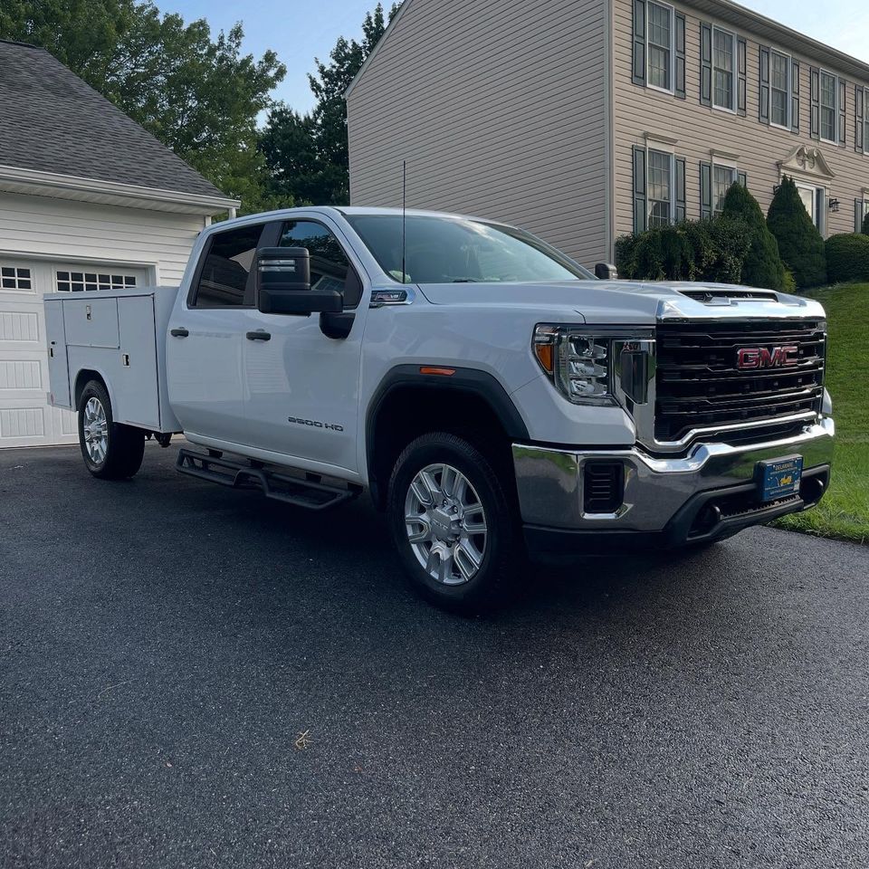 White GMC Sierra 2500HD service body work truck freshly cleaned through fleet washing in Wilmington Delaware