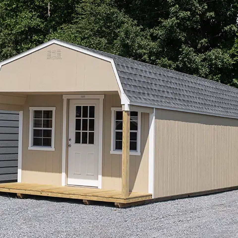 Tan Dutch cabin with front porch, windows and shingle gambrel roof in Knoxville TN
