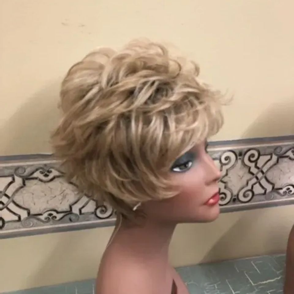 Short blonde layered wig displayed on a mannequin, featuring soft volume, textured waves, and a natural appearance.