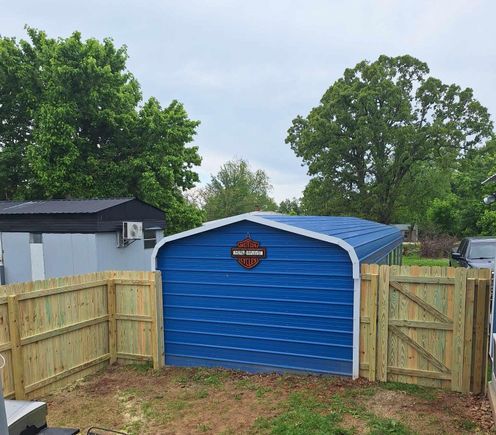 Privacy fence around blue shed