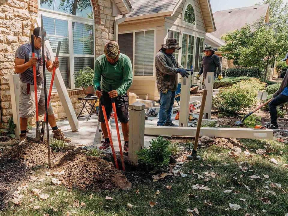 Professional fence installation crew installing residential fencing in the Lake Norman area