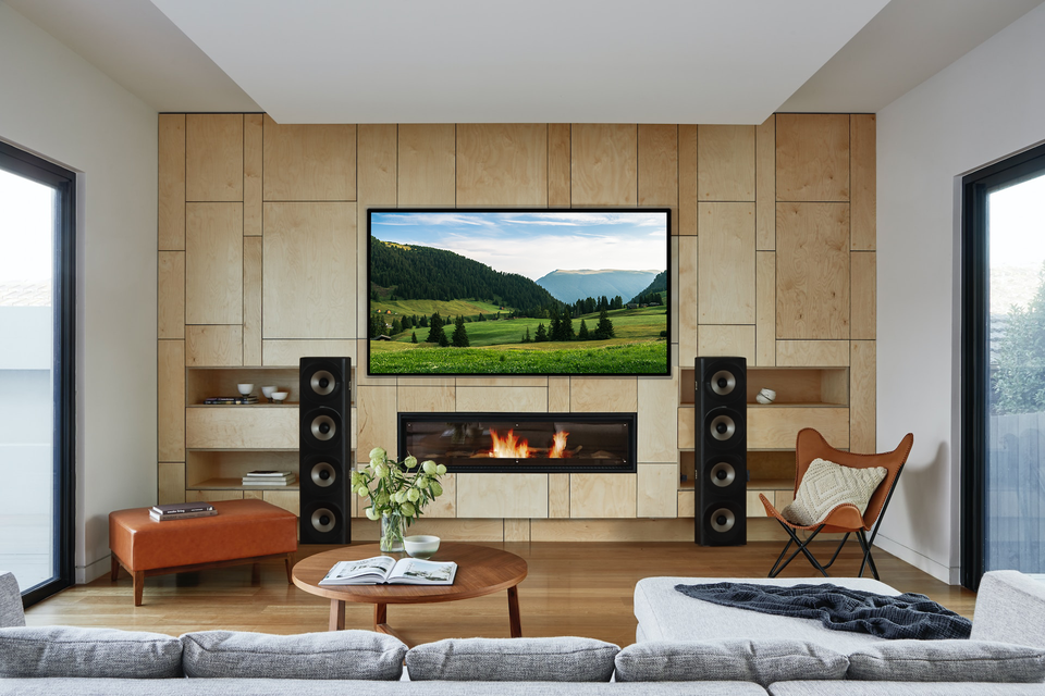 Home theater in Greer, SC featuring a large screen showing a football game, with comfortable seating and a dedicated sports fan atmosphere.