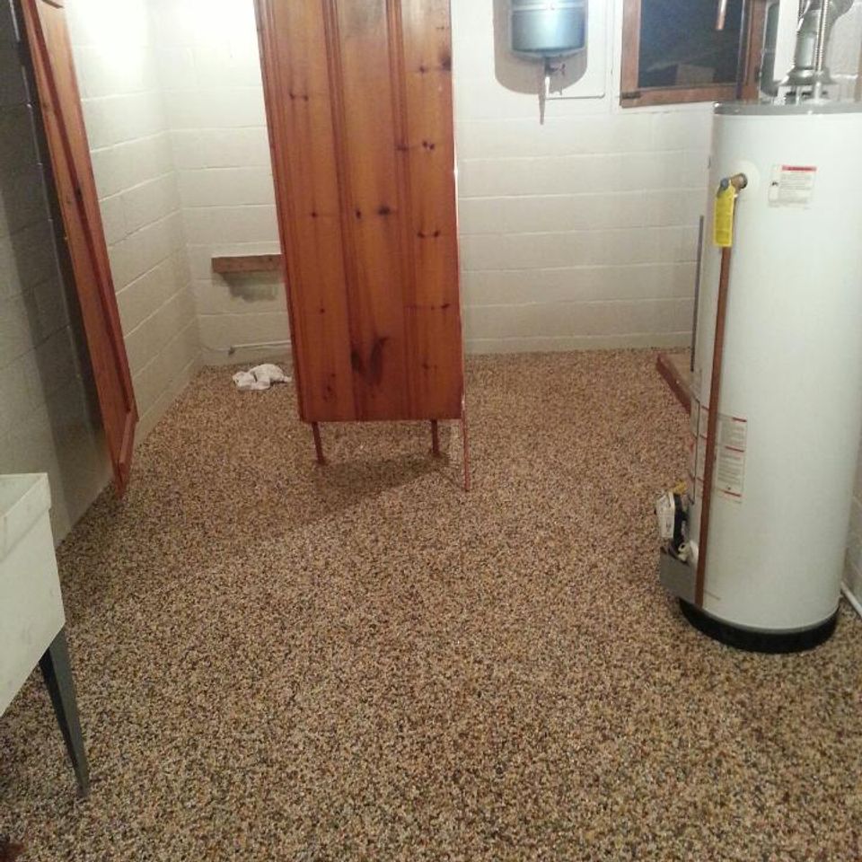 Utility room with an EverStone decorative stone flooring system.