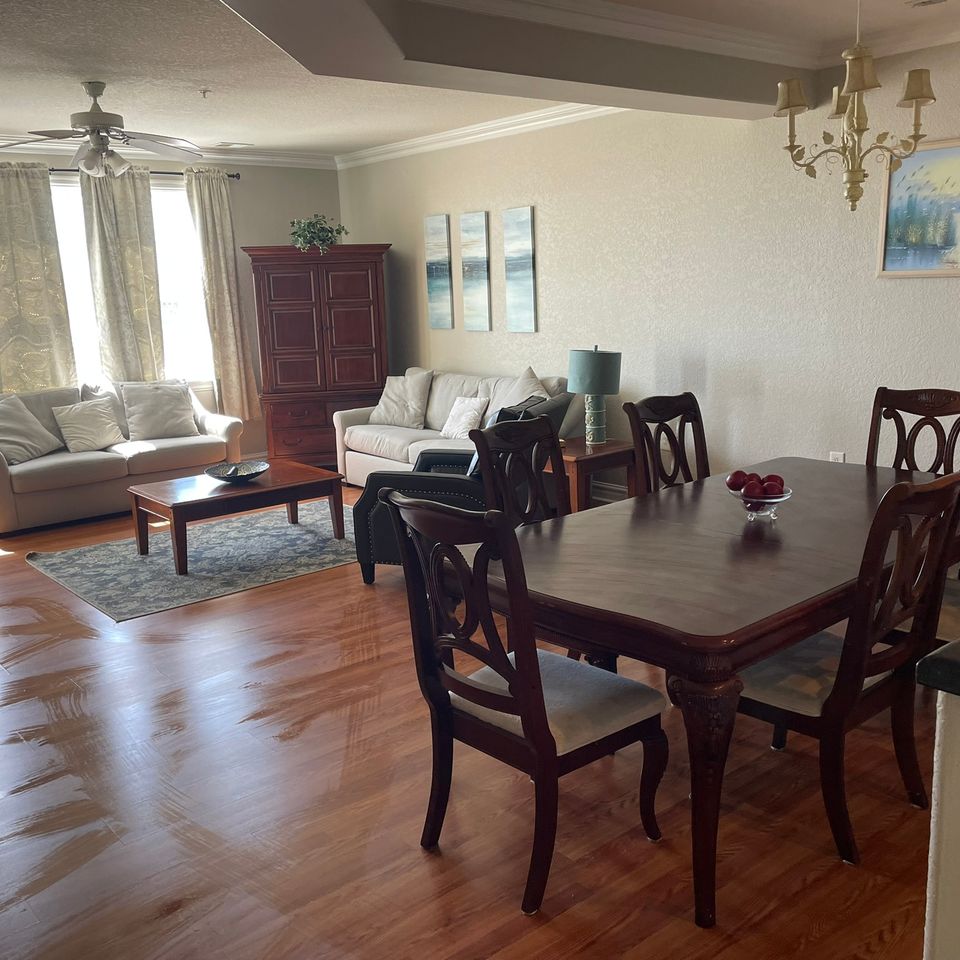 Tidy living and dining room with polished hardwood floor after house cleaning service in Virginia Beach VA