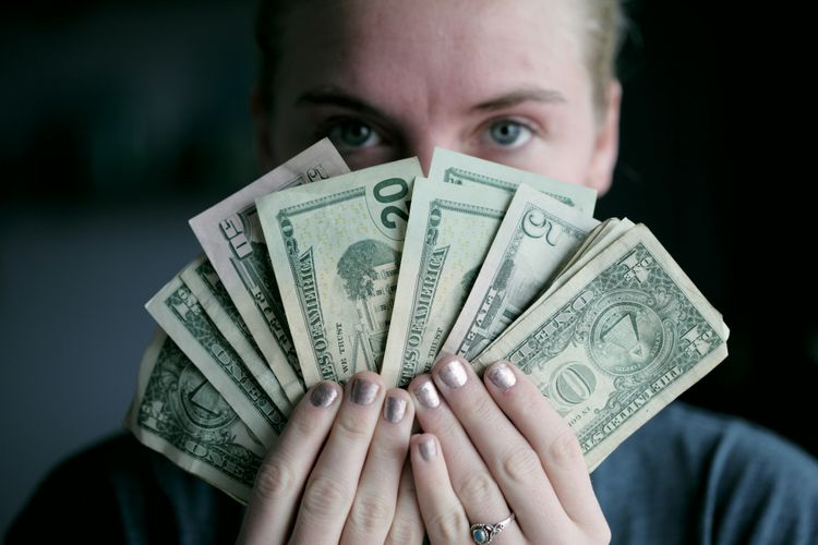 Seller holding cash from selling secondhand items