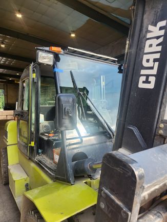 Close-up of a newly installed cab glass during heavy-duty equipment glass service.
