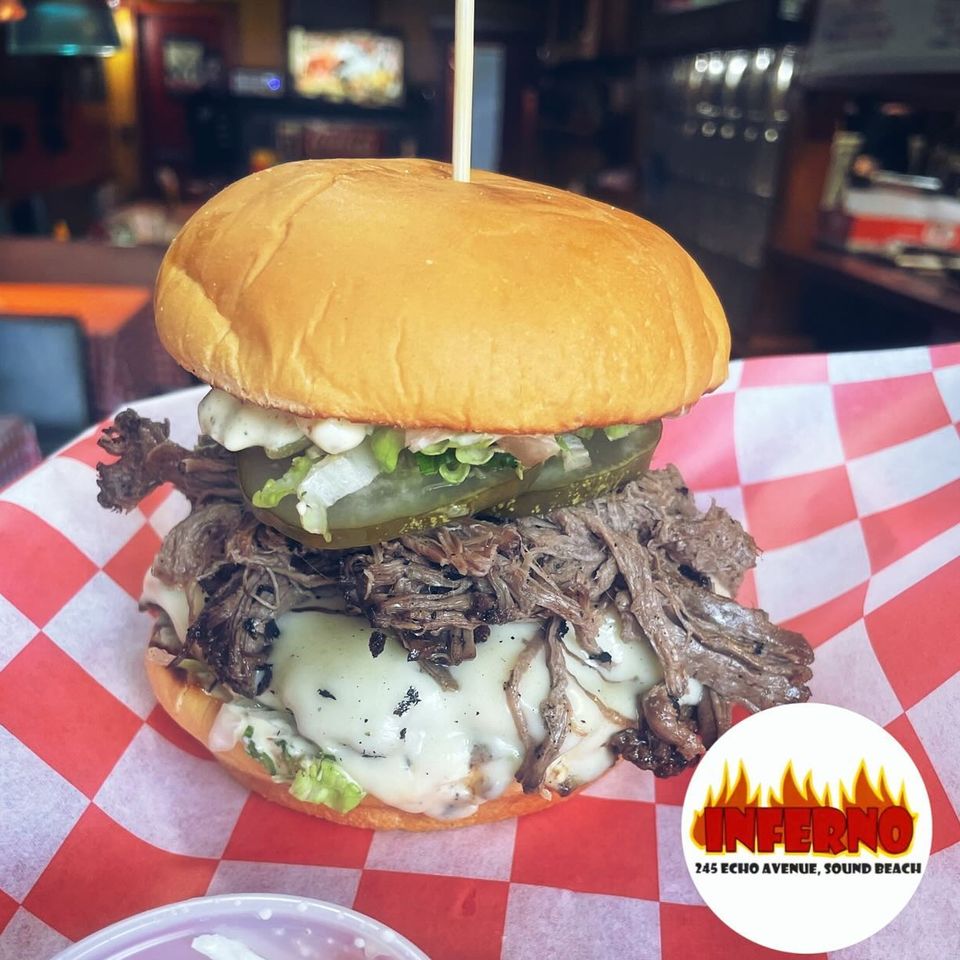 Hamburger with pulled pork, pickles and other toppings from Inferno The Restaurant in Sound Beach