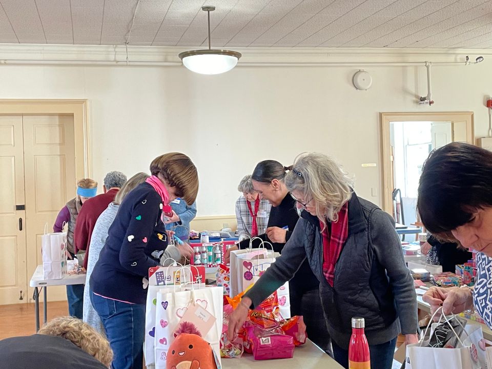 Community volunteers fill valentine bags