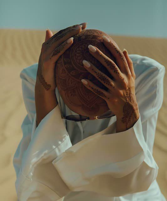 Henna tattooed head and hands 