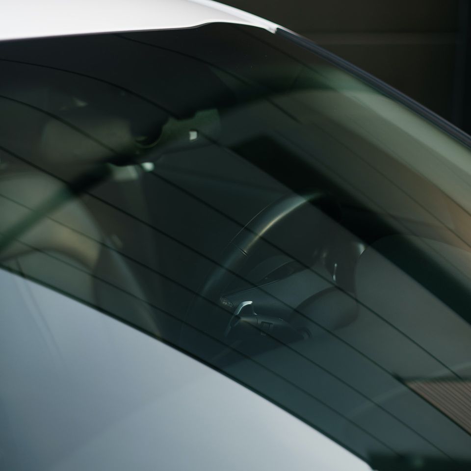 Vehicle windshield viewed from the exterior, clean and professionally installed auto glass.