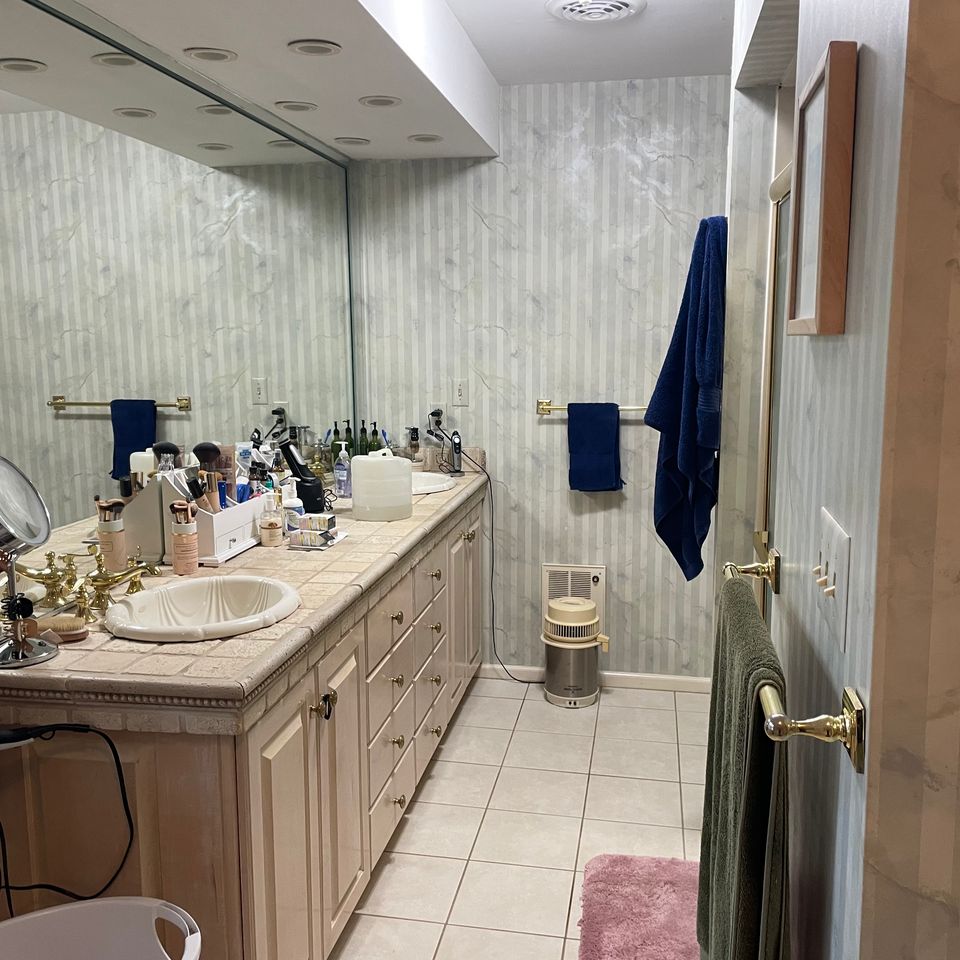 Tidy bathroom vanity with double sinks and mirror after a house cleaning service in Virginia Beach VA