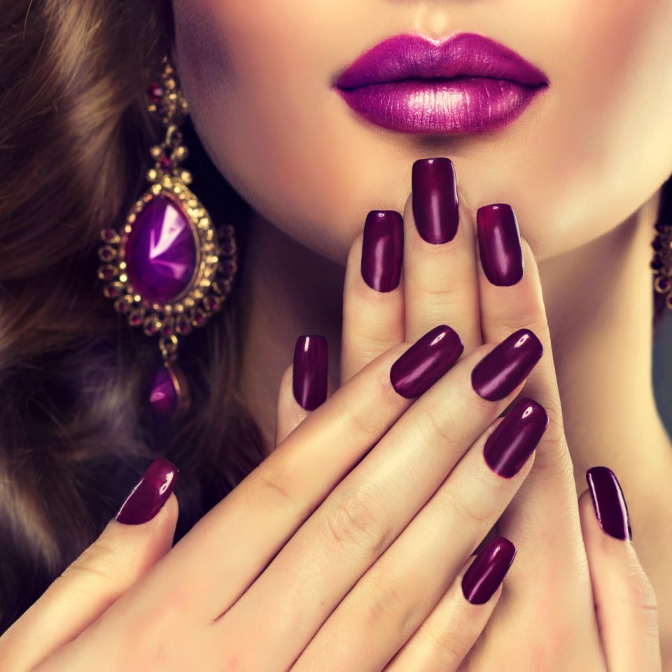 A woman with pink painted nails after her dip powder service