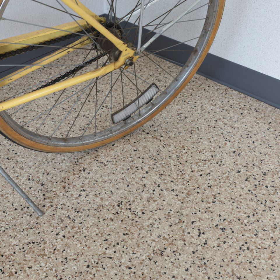 Bicycle parked on tan EverStone Flakes flooring.