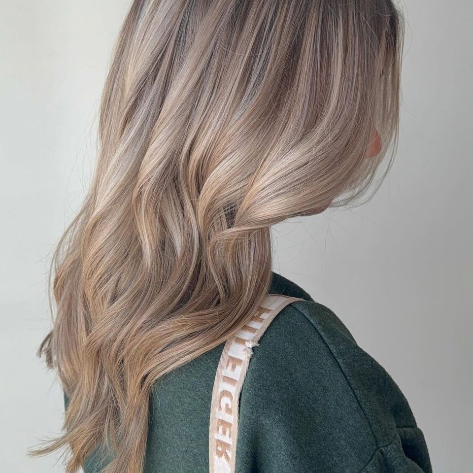 Long wavy bronde balayage with soft dimensional highlights after color service in Columbiana AL
