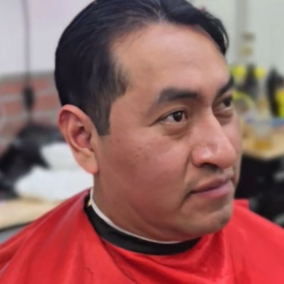Adult Hispanic male receiving a classic haircut at Bronx NY barbershop Jeff Barber Services