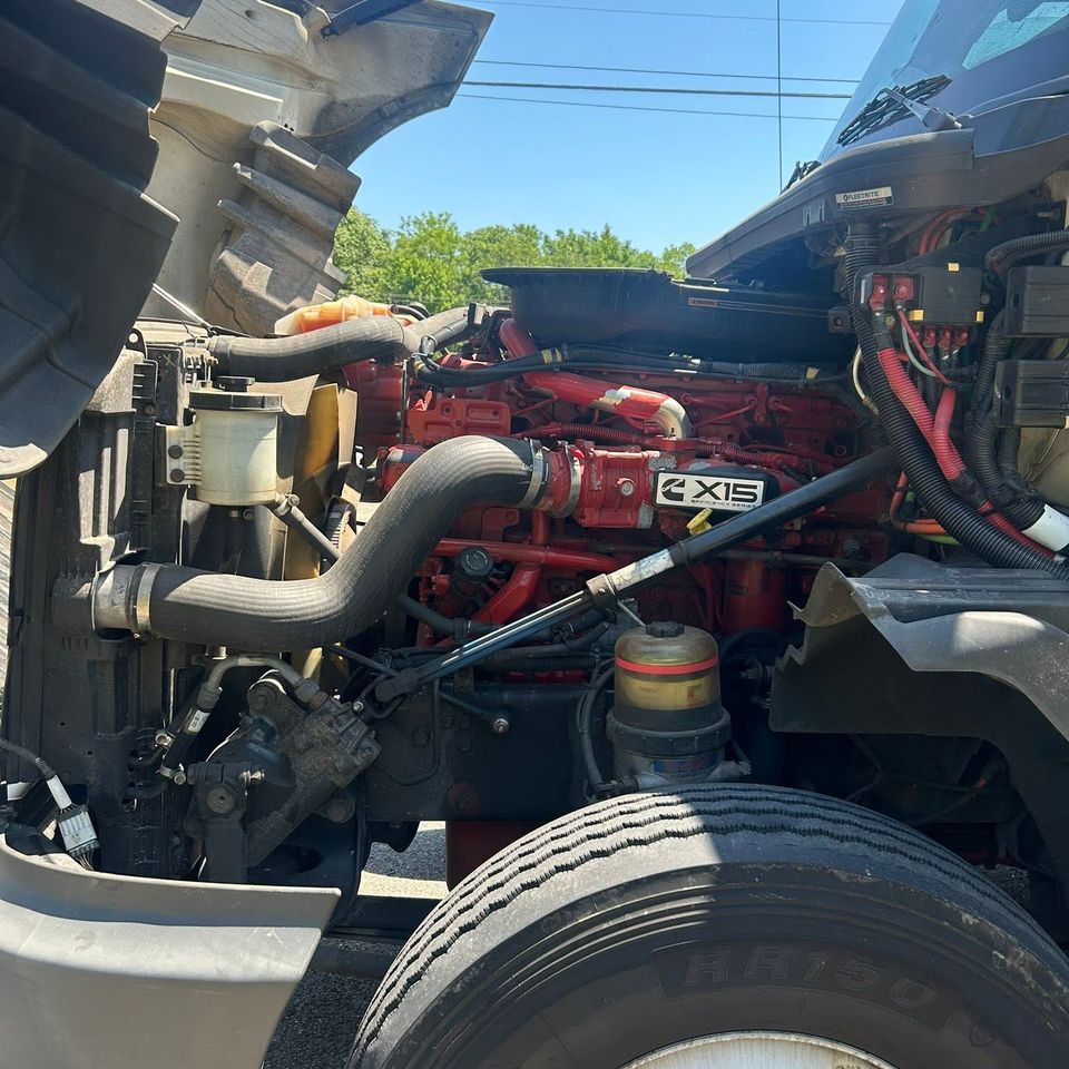 Cummins X15 diesel engine exposed under raised hood during semi-truck repair in Arab Alabama