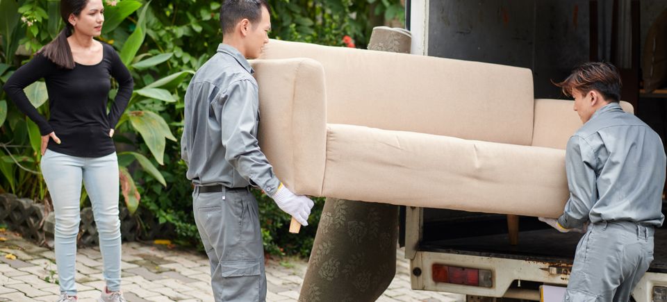 Movers loading couch van