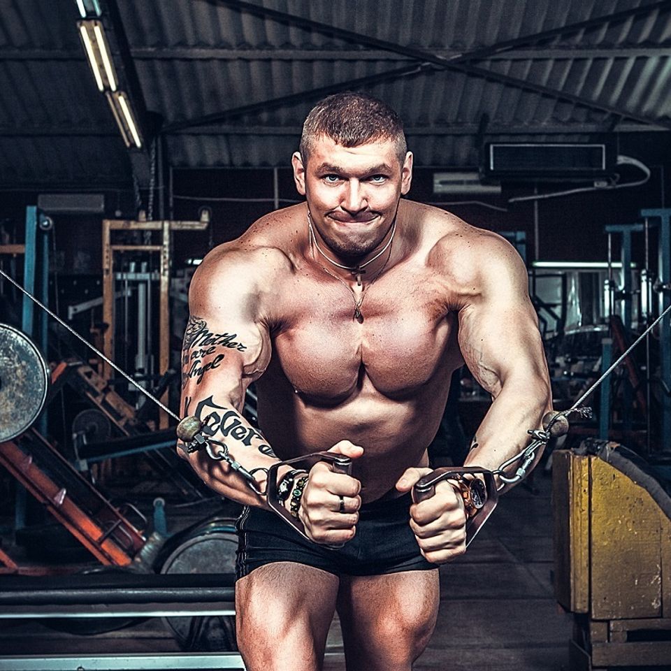 Buff guy pulling weights with pure man pump