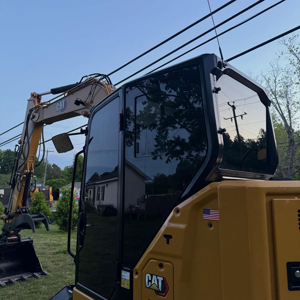 Cat 308 excavator cab with dark tinted glass after heavy equipment tint in Moyock North Carolina