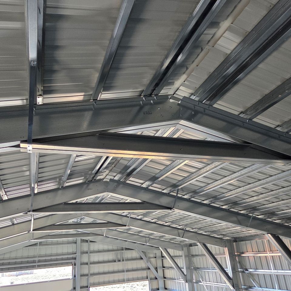 Close-up of galvanized purlins and steel roof trusses in a custom metal building