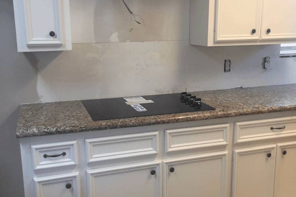 Kitchen remodel in progress with backsplash installation and updated cabinets in Spring Texas