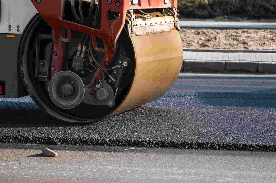 asphalt roller maintaining a city road