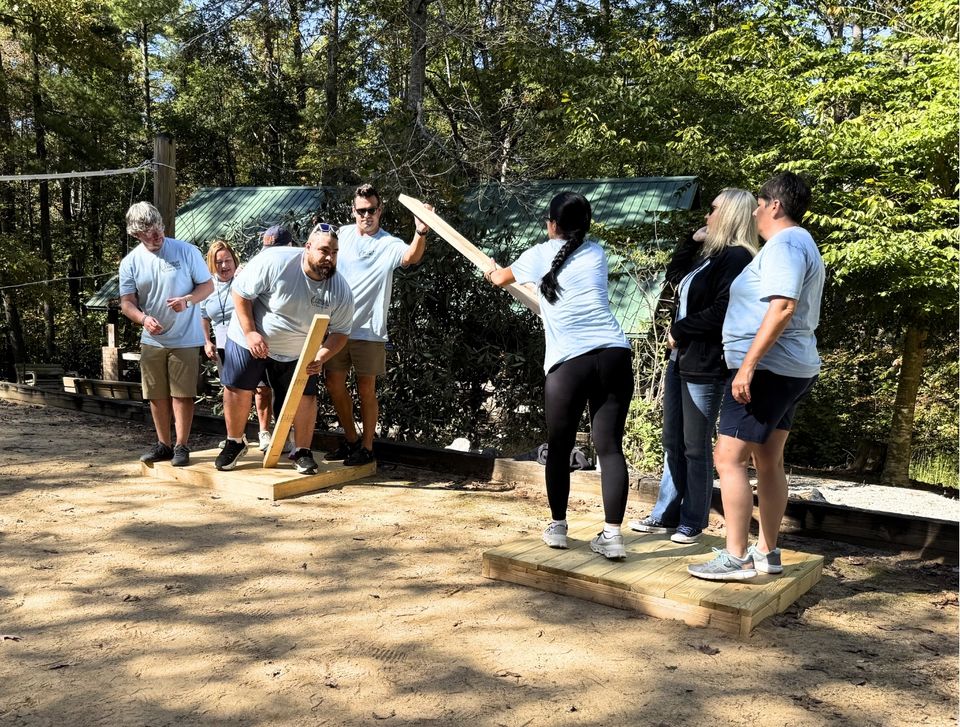 Corporate team participating in experiential leadership development workshop