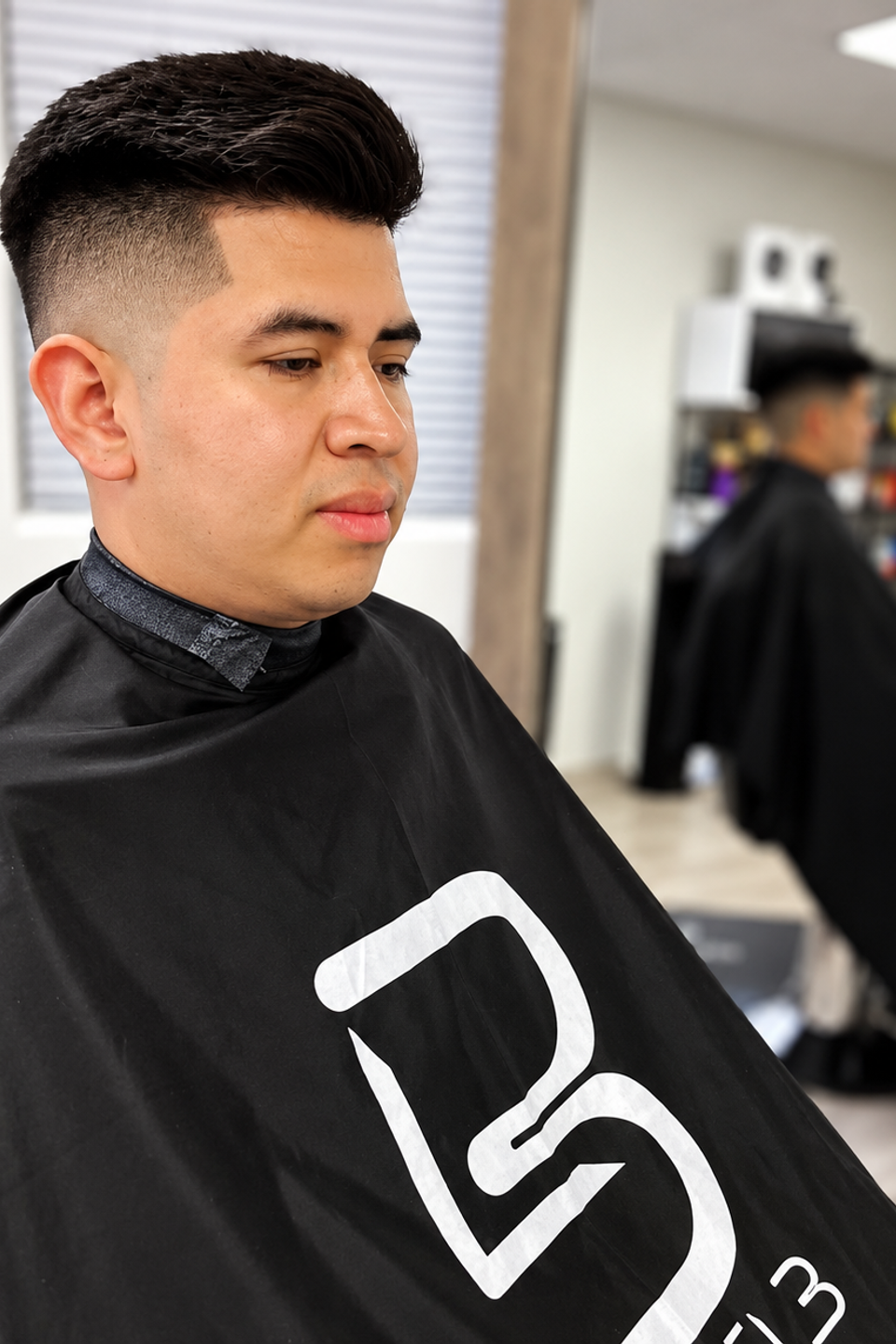 This image shows a man with a fade after a fresh haircut. 