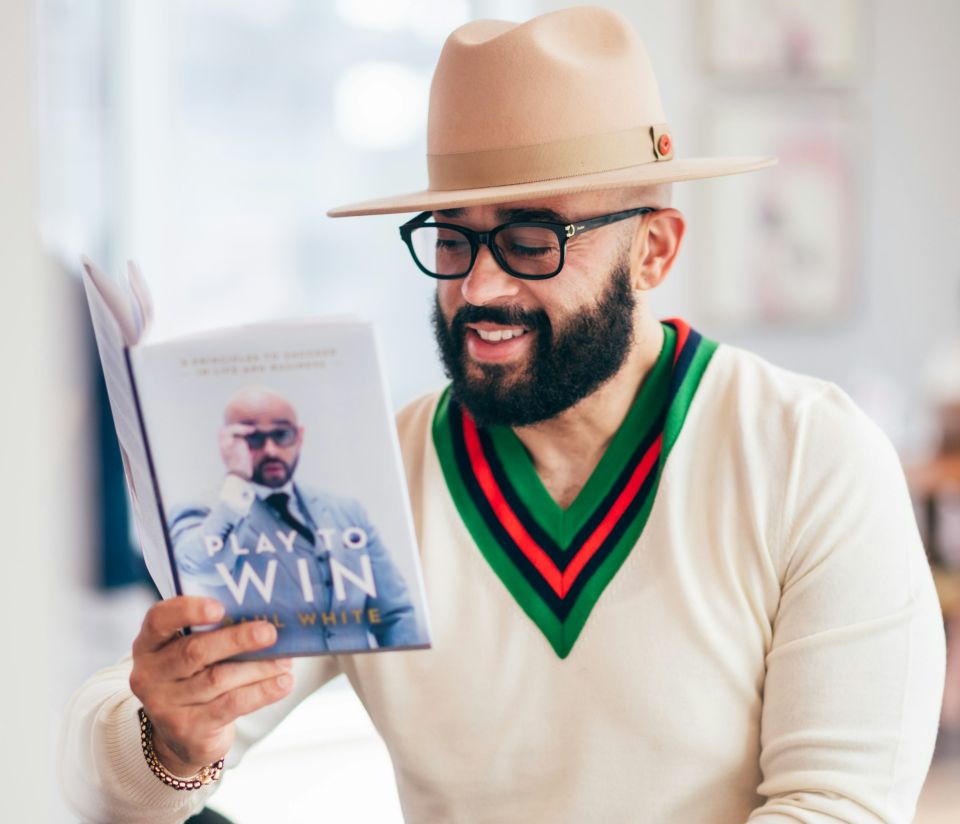 Stock image of an author reading a book featured in a blog about author website design by Cannone Marketing