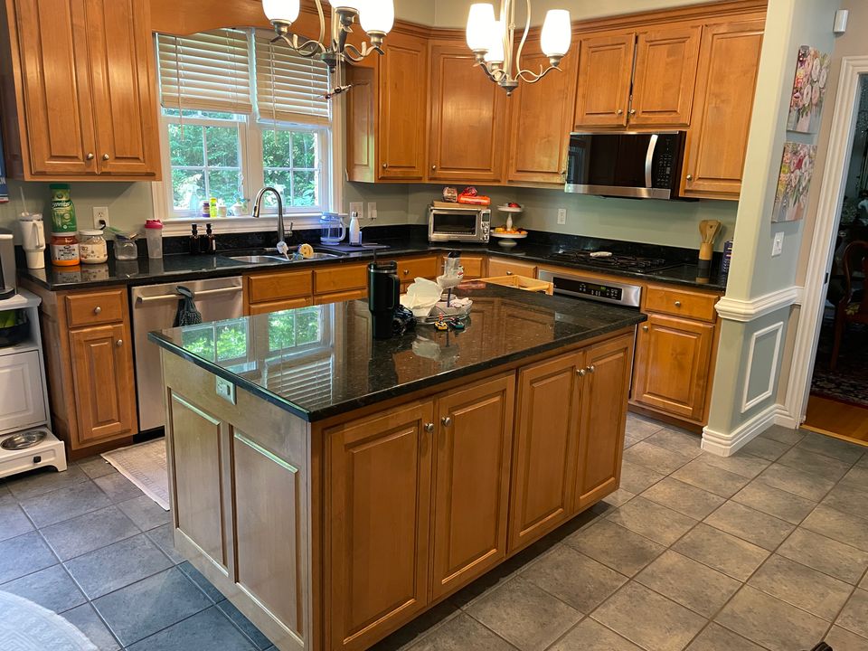 Clean kitchen with granite island and stainless steel appliances after a house cleaning service in Virginia Beach VA