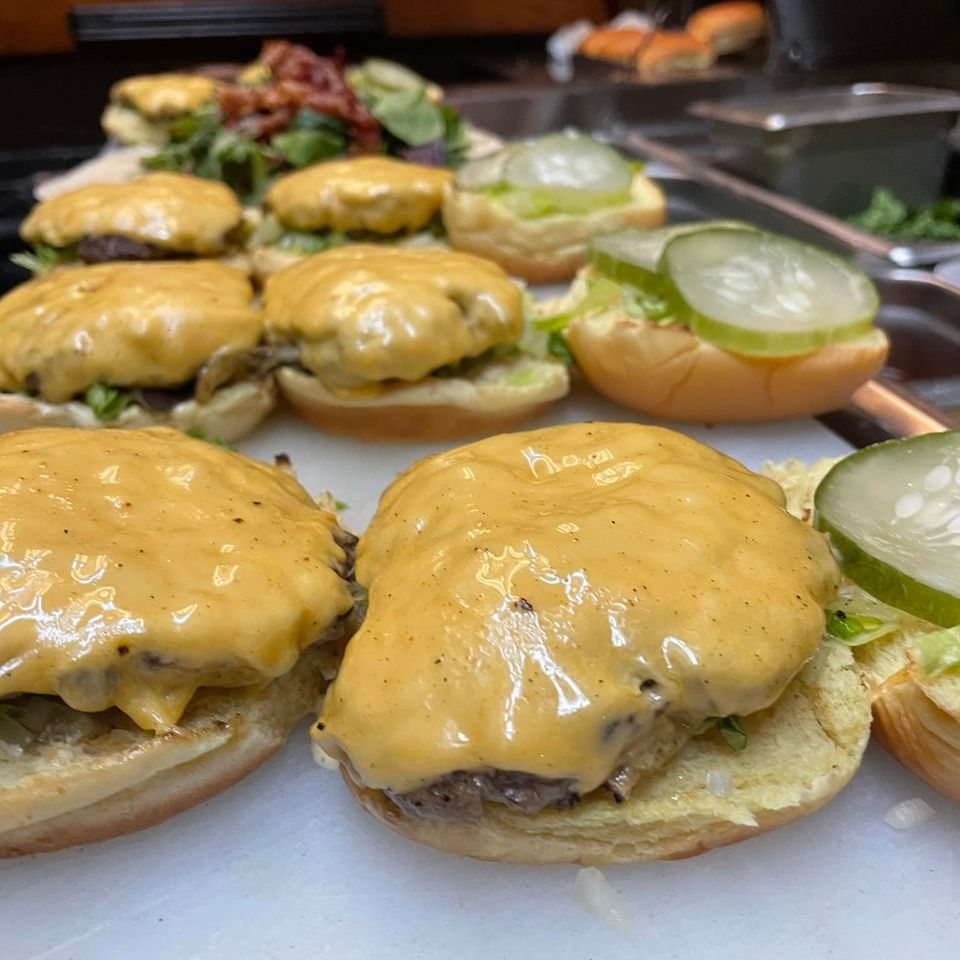 Cheeseburgers getting prepared from Inferno The Restaurant in Sound Beach
