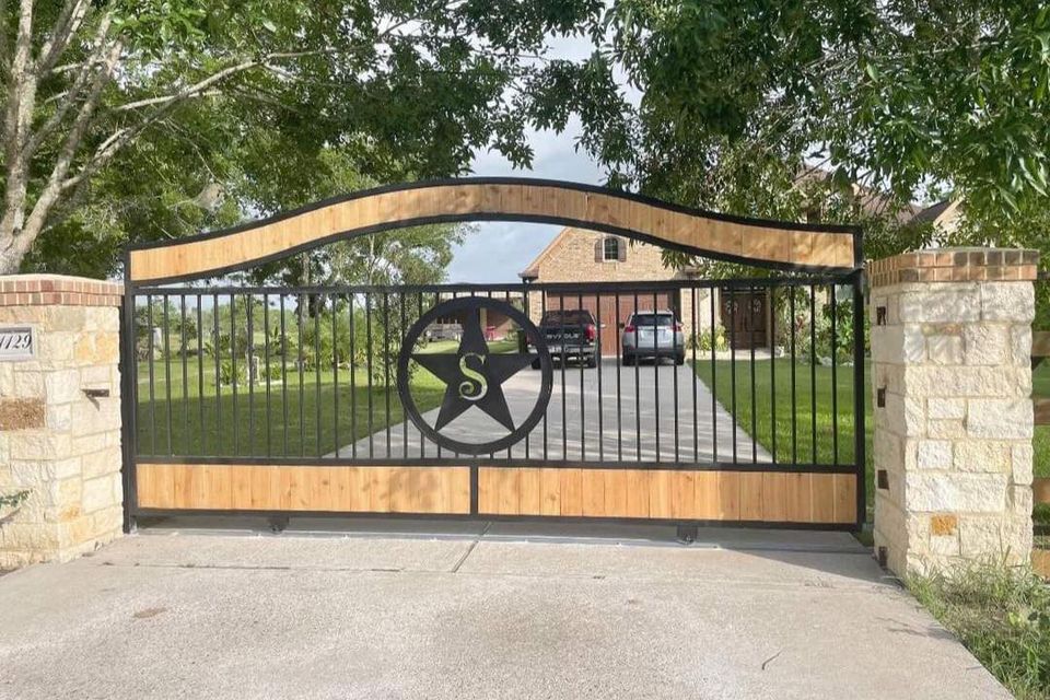 Black iron gate with an s logo