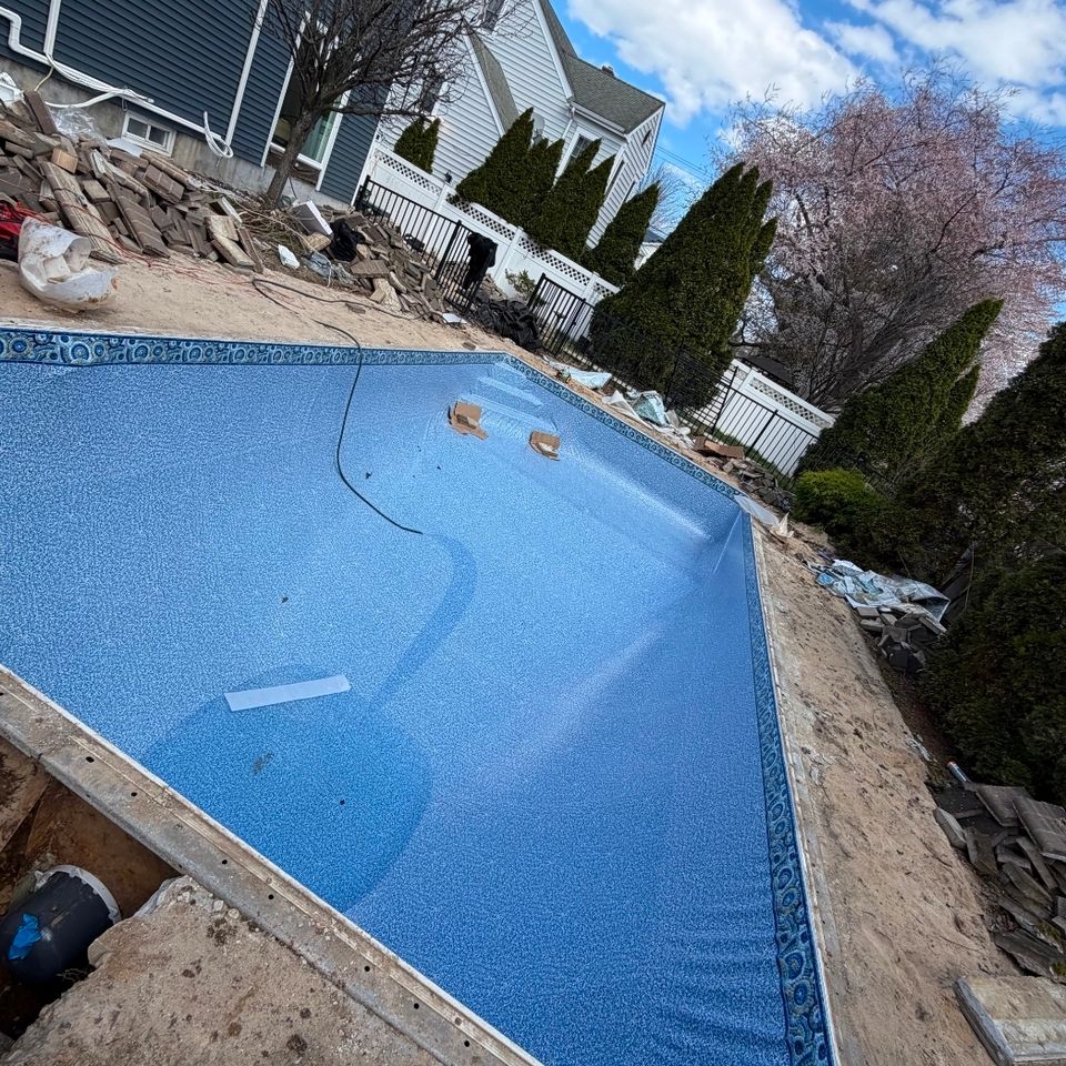 Rectangular inground pool with new liner and tile border before the patio is rebuilt