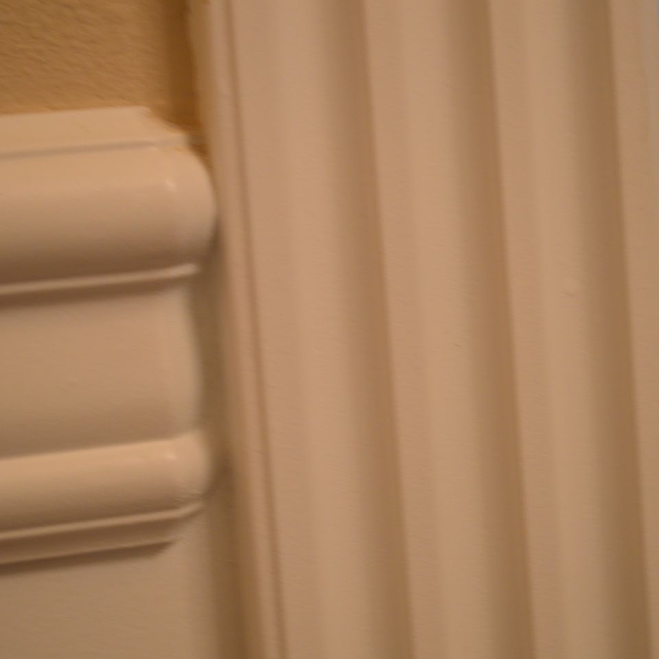 Close-up of fluted casing and paneled trim showing custom home millwork detail